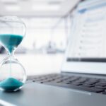 Hour,Glass,On,Laptop,Computer,Keyboard,Concept,For,Time,Management