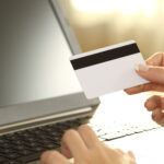 Girl,Hands,Holding,Credit,Card,And,Buying,On,Line,Sitting