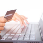 Hand,Holding,Credit,Card,And,Typing,Keyboard,Laptop,Computer.,Shopping