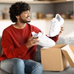 Portrait,Of,Happy,Young,Indian,Man,Unboxing,Parcel,With,Shoes