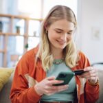 Woman,,Credit,Card,And,Phone,For,Online,Shopping,In,Home