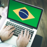 People,Using,Laptop,And,Showing,On,The,Screen,The,Flag