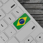 Brazil,Flag,Enter,Key,On,White,Keyboard,,On,Wood,Background.