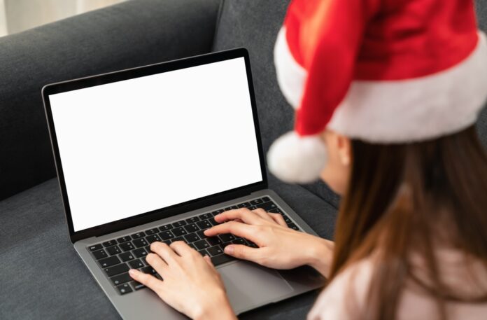 Woman,Wearing,Red,Christmas,Hat,And,Hand,Type,On,The